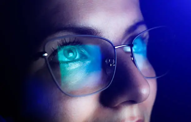 A girl wearing blue light filter glasses